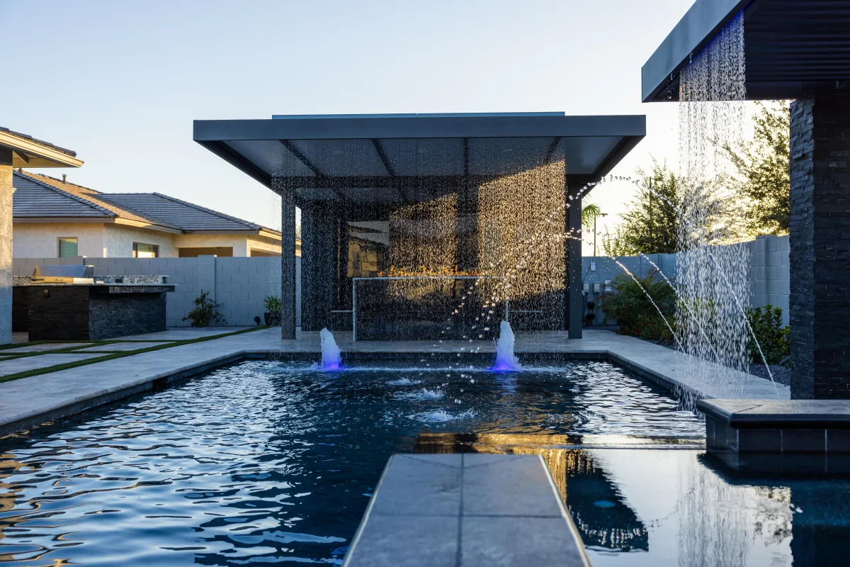 Luxury Arizona custom pool with rain curtains, deck jets, and a covered outdoor living area